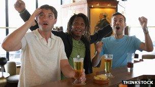 Men watching sport in a bar