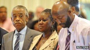 The parents of Trayvon Martin stand with Reverend Al Sharpton at a rally marking one month since their son's death in Sanford, Florida, 26 March 2012