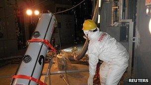 A worker conducts measurements inside the primary containment vessel at Tokyo Electric Power Co. (TEPCO)'s tsunami-crippled Fukushima Daiichi nuclear power plant No 2 reactor