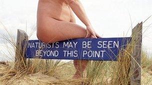 A sign at a nudist beach