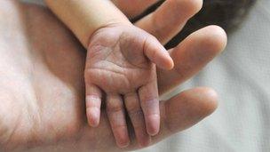 Hands of mother and baby