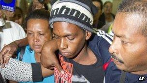 Rescued castaway Adrian Vasquez, second from right, surrounded by family members