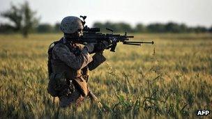 US Marines Lance Corporal Michael Horne gets ready to open fire in Sistani, Helmand Province May 7, 2011