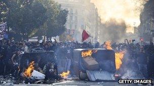 Demonstrators set fire to garbage containers during heavy clashes with riot police during a 24-hour strike on 29 March, 2012 in Barcelona, Spain.