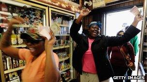 Tammy Redlen (C) and Sierra Luchien (L) are jubilant as they walk in Blue Bird liquor store after waiting in line for nearly three hours to purchase their Mega Millions lottery ticket on March 29, 2012 in Hawthorne, California.