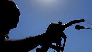 Silhouette of man at petrol pump