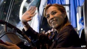 Josefina Vazquez Mota sitting at the wheel of a bus, waving. 30 March 2012