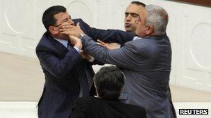 Members of Turkey's parliament fight during the debate on the Education Reform Bill