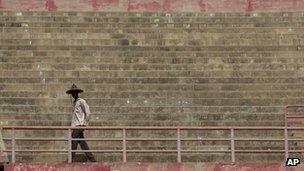 A man wearing a traditional hat arrives at a rally in support of the ruling military junta, attended by roughly 1,000 people in a stadium with a capacity of 50,000, in Bamako, Mali