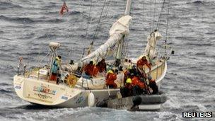 US Coast Guard crew work to transfer the two injured crew