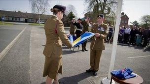 The 5th Division flag is folded as Brigadier Mark Banham, the Lord Lieutenant of Shropshire, and Brigadier David Short, Chief of Staff Support Command, salute.