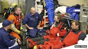 Medical staff attend to Dr Hitchens (second right) and Mr Brbora (far right).