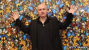 Damien Hirst in front of his Doorways to the Kingdom of Heaven artwork