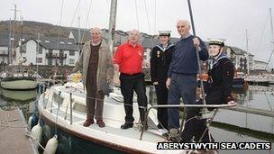 Sir John Houghton (right) and Donald Harris (far left) on Facit with representatives from the sea cadets