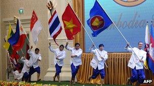 Performers carry flags of Asean member countries during a ceremony marking its 45th anniversary