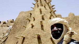 Residents of Timbuktu restore the City of 333 Saints' Djingareyber Mosque 10 April 2006 ahead of the Maouloud festival, marking the birth of the Muslim Prophet Mohammed.