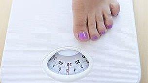 Woman weighing herself