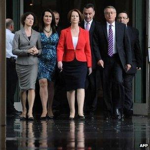 Julia Gillard (C) arrives with supporters for the caucus meeting in Canberra, 22 February 2012