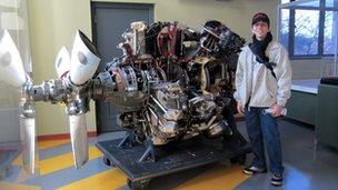 Man stands in front of engine