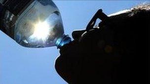 Woman drinking water in the sunshine