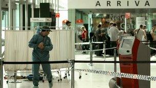 File photo taken March 22, 2009 shows a member of the Australian police forensic personnel at a crime scene at Sydney airport's Terminal 3.