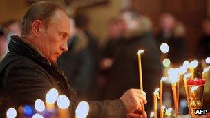 Vladimir Putin lighting candle in church, 7 Jan 11