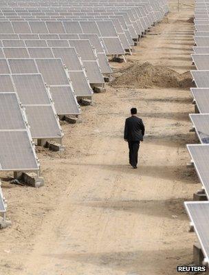 Man walking through a solar power array (Image: Reuters)