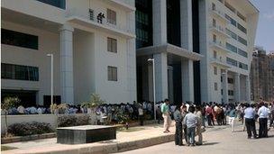 Buildings, people outside, Bangalore. Photo: Richy Panicker.