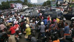 Crowds of people try to make it to higher ground in Aceh, Sumatra, Indonesia.