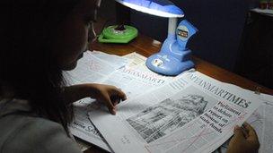 Shwe Yin Mar Oo, chief political reporter of Myanmar Times, surveys a heavily censored newspaper copy.