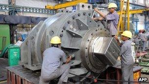 Labourers work on heavy machinery at the in Gujarat state - 28 October 2010