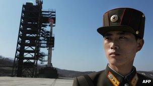 A soldier guards the Unha-3 rocket at North Korea's Tangachai-ri space centre, 8 April