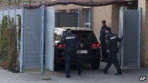 Danish police meet a car carrying one of the defendants to court in Glostrup, Copenhagen, 13 April