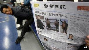 A subway passenger reads a South Korean newspaper Chosun Ilbo reporting North Korea"s rocket launch