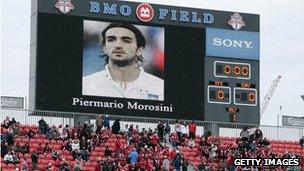 Fans in Toronto, Canada, hold a minute's silence before the MLS game against Chivas USA