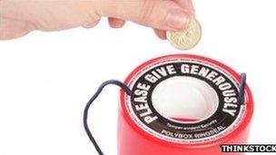 Person placing money in charity collection tin (generic)