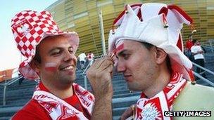 Polish football fan painting second fan's face