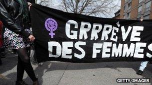 Banner with raised fist in purple symbol for women, on gender equality march in France