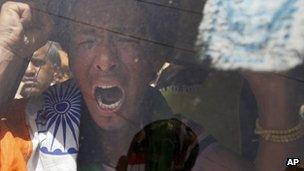 A Tibetan exile shouts slogans as he is detained by Indian police during a protest against the visit of Chinese President Hu Jintao