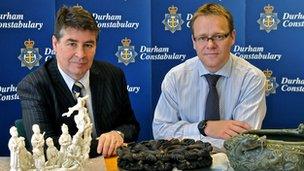 Police pose with recovered artefacts