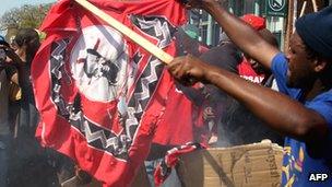 Protesters burning flags of the king in September during a march