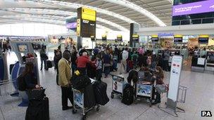 Passengers queuing at Heathrow airport