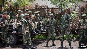 Soldiers of the Democratic Republic of Congo Armed Forces stand outside a general's residence in Goma on 11 April 2012