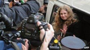 One of the "Pussy Riot" defendants, Yekaterina Samutsevich, waves as she arrives for her court hearing in Moscow, 19 April