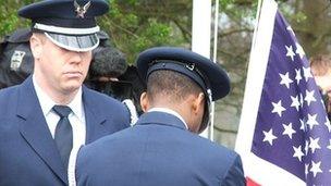 A flag is raised at a memorial to USAF personnel at Henham Park