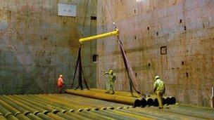 Steel pipes being loaded