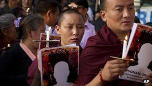 Exile Tibetans in India participate in a candle lit vigil to mark the two latest self-immolations in Tibet. Thursday, April 19, 2012