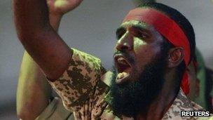 Supporters shout and gesture as Sudanese President Omar al-Bashir (R) addresses a rally at the ruling National Congress Party (NCP) headquarters in Khartoum April 18, 2012