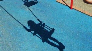 child's shadow on swing