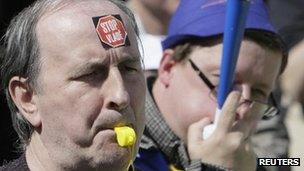 Protesters with stickers "Stop the government" blow whistles in Prague